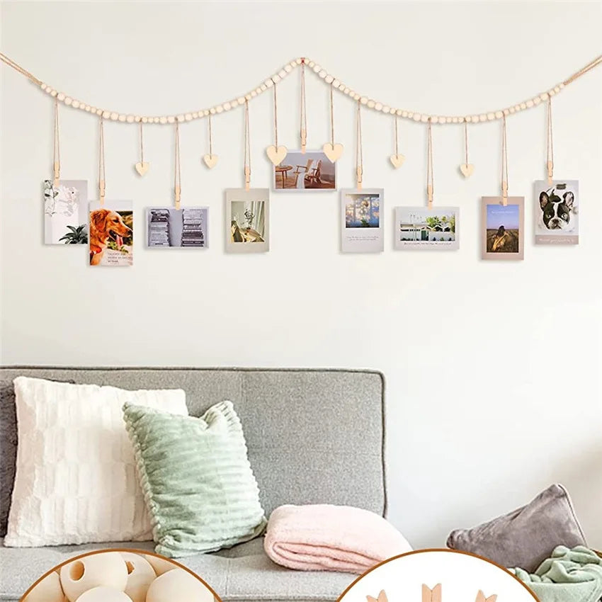 heart accent wood bead garland photo display above a light gray sofa with pillows