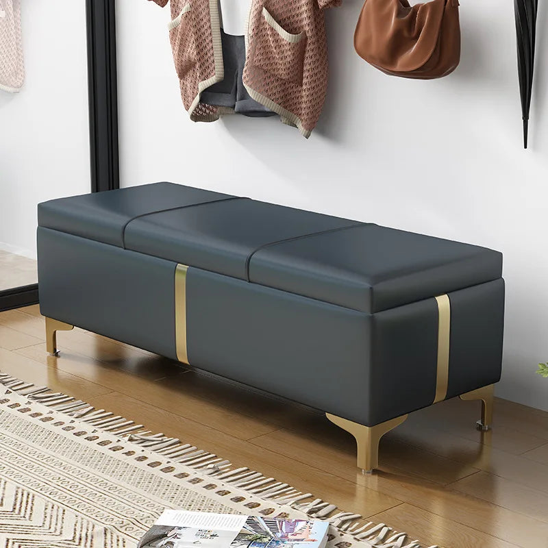 Dark green upholstered storage ottoman bench with gold legs in an entryway setting