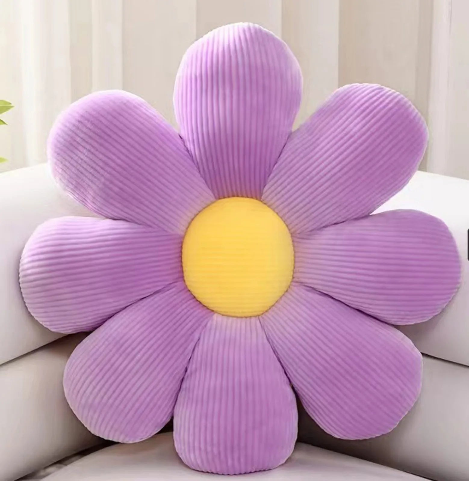 Purple daisy flower cushion pillow displayed on light sofa in cozy room
