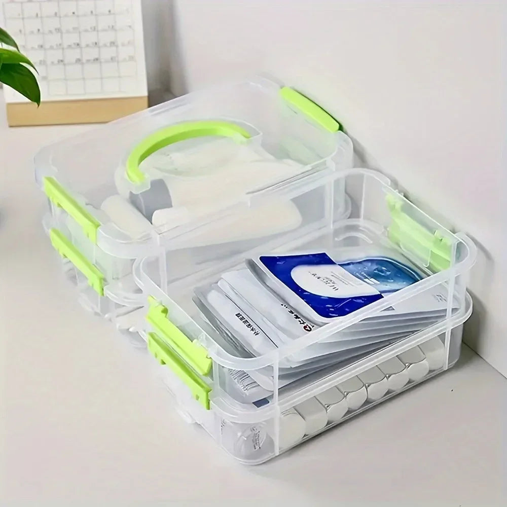 Clear organizer boxes stacked and used to store face masks and household supplies on a desk