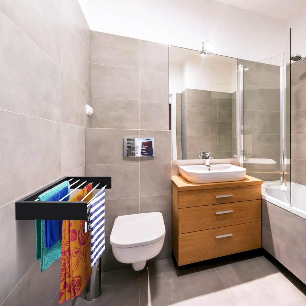 Black wall-mounted drying rack with towels in a modern bathroom with neutral tile and wood accents