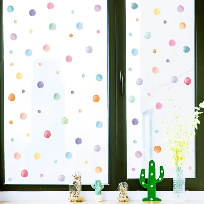Removable multicolor dot wall stickers displayed on bright window glass