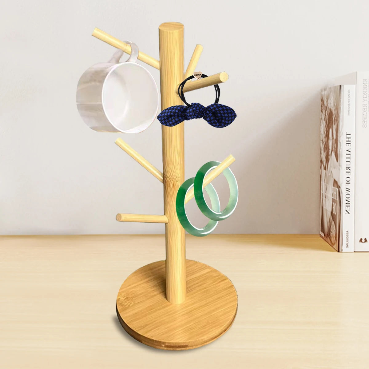 Round bamboo mug tree on tabletop with mug and accessories displayed