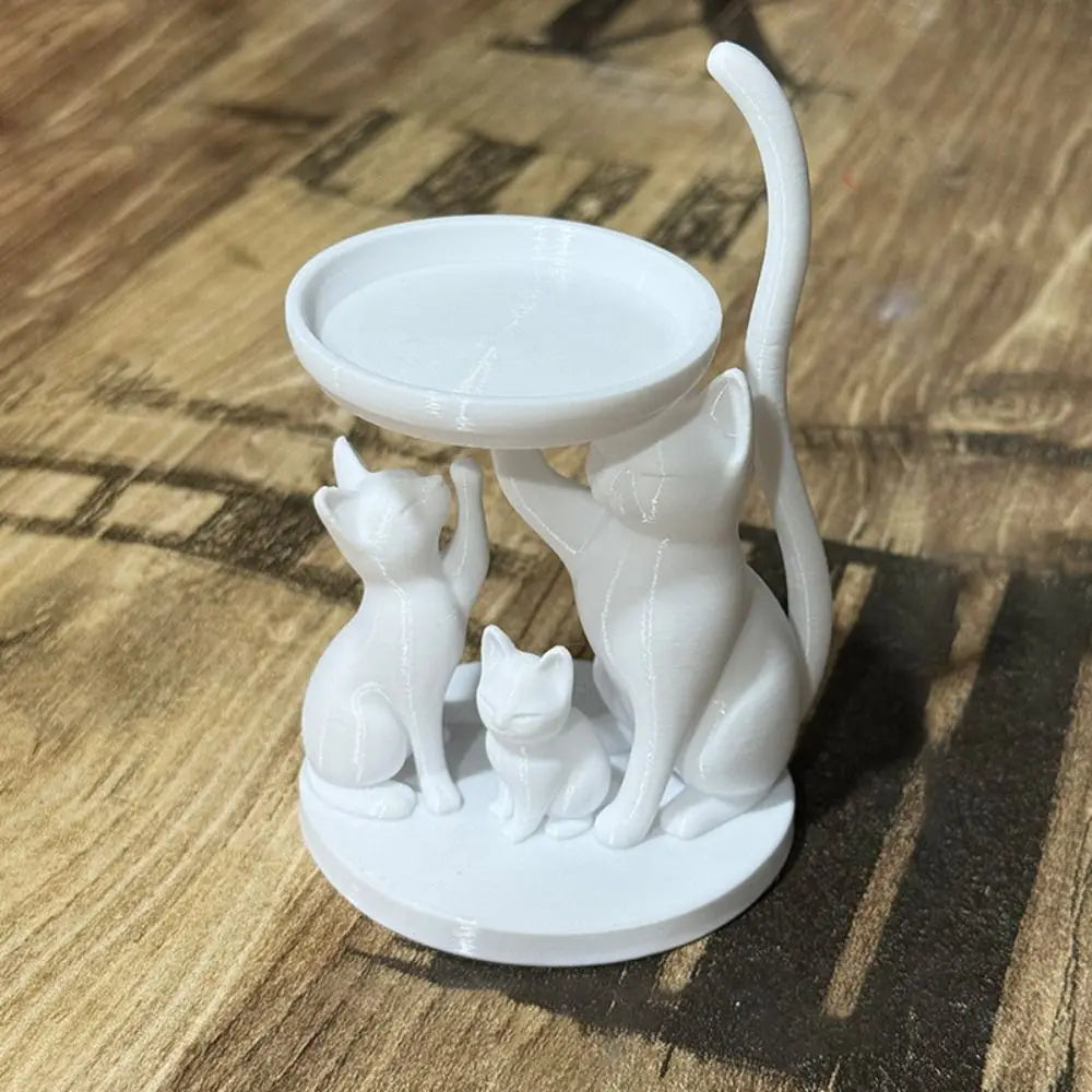 White cat jewelry tray on a tabletop showing sculptural details