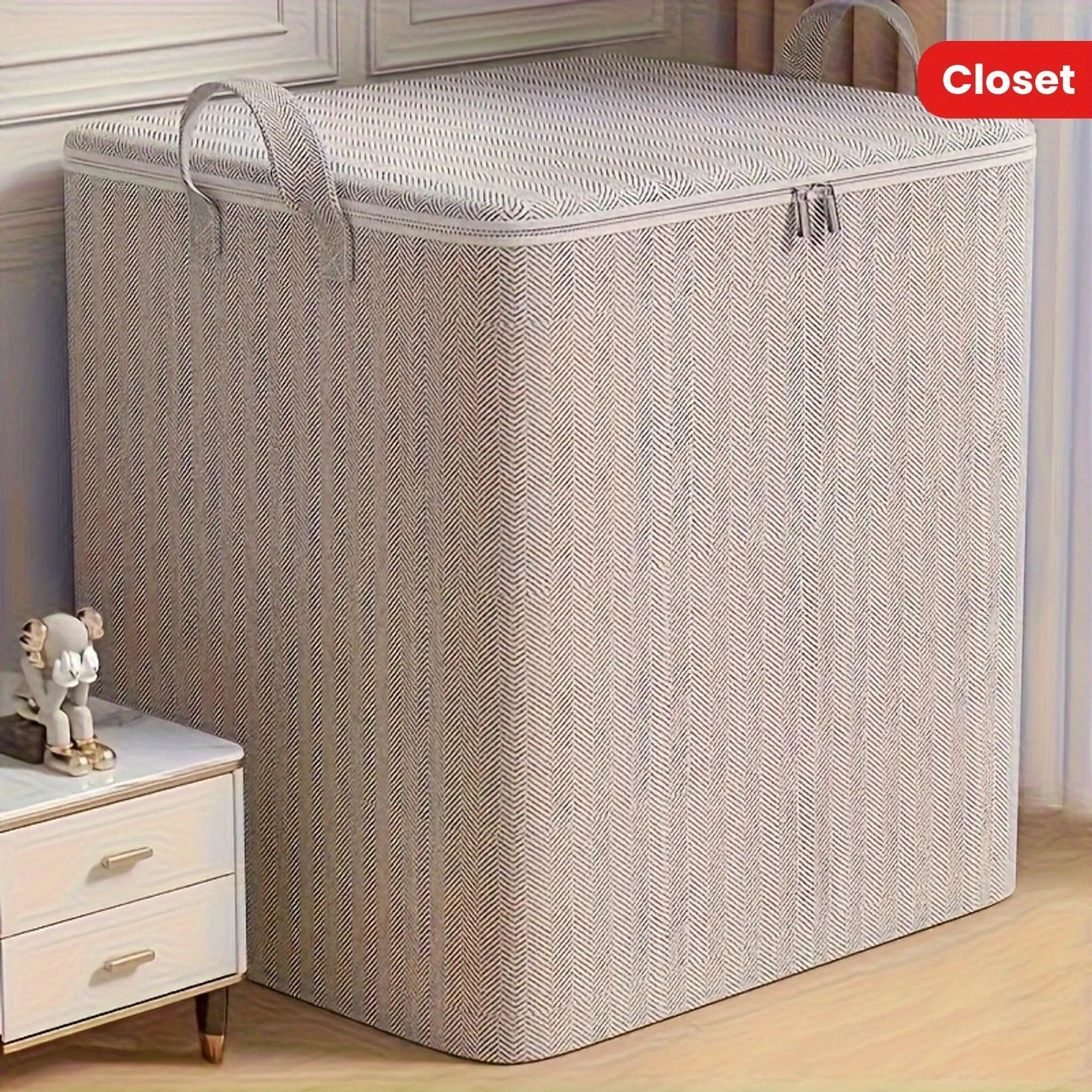 Large rectangular closet storage box with lid and handles placed next to a nightstand