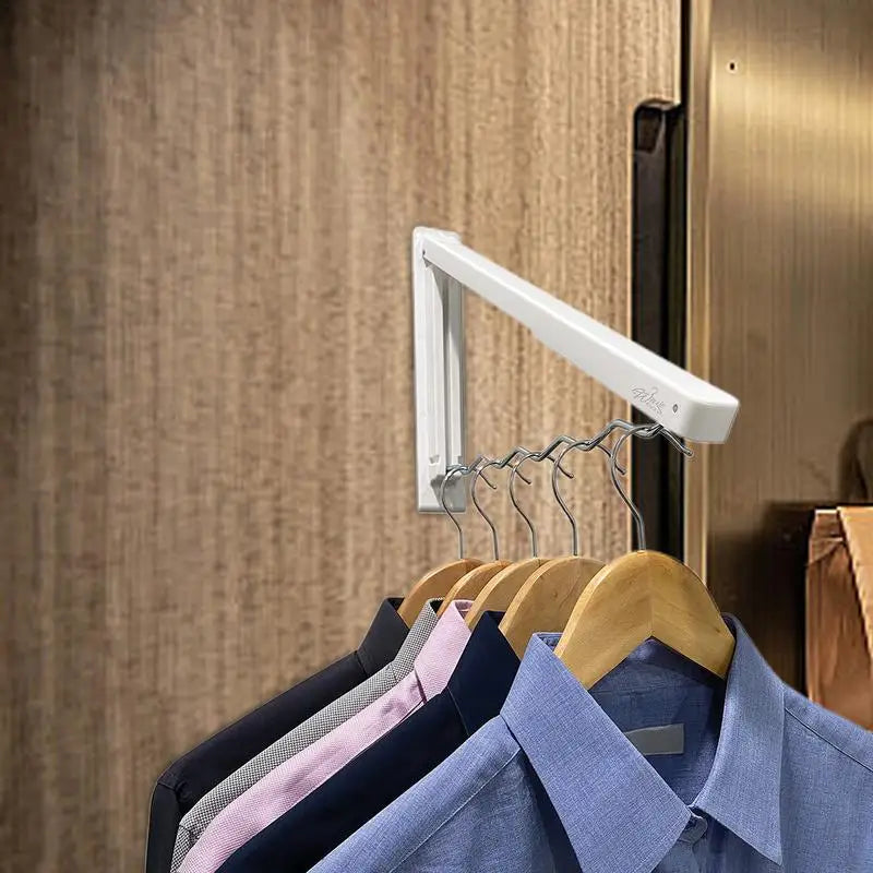 Wall-mounted drying rack holding multiple shirts on hangers