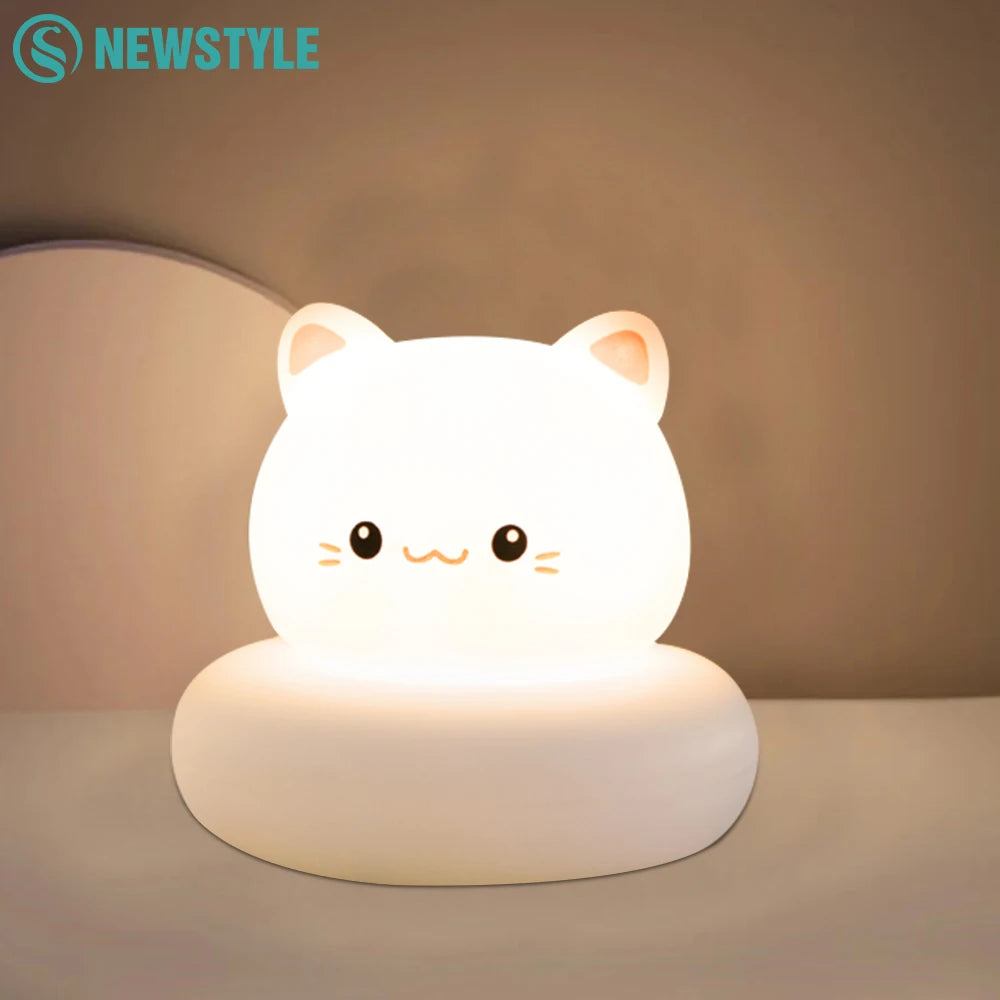 Cat shaped LED night light glowing softly on a bedside table