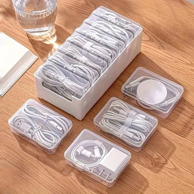 Stackable cable organizer box set shown holding several coiled charging cables and adapters on a wooden surface