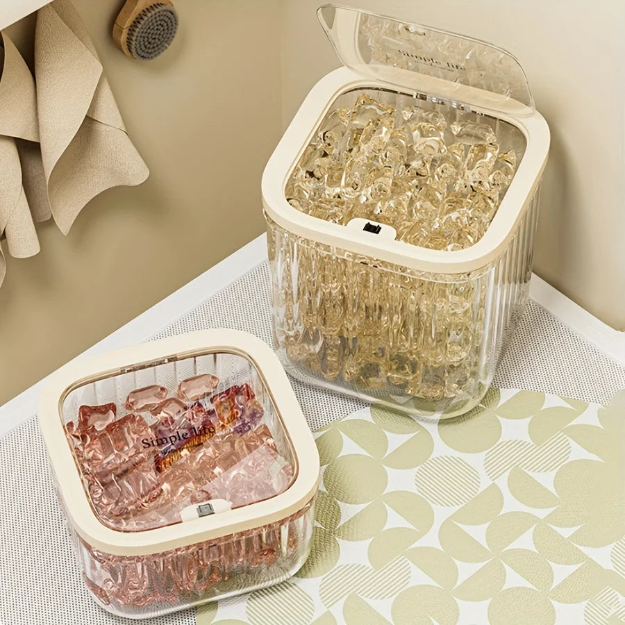 Two clear plastic flip-top bins filled with laundry capsules on a laundry room shelf