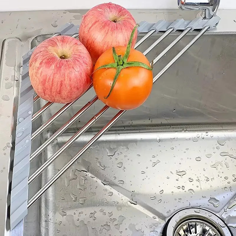 triangular roll-up drying rack over kitchen sink with apples and tomato