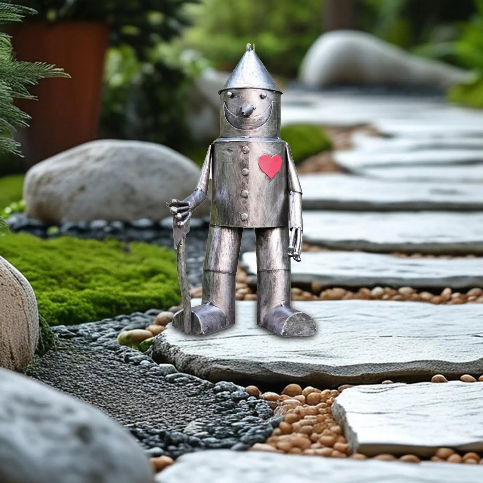 tin man garden statue placed along a stone garden path