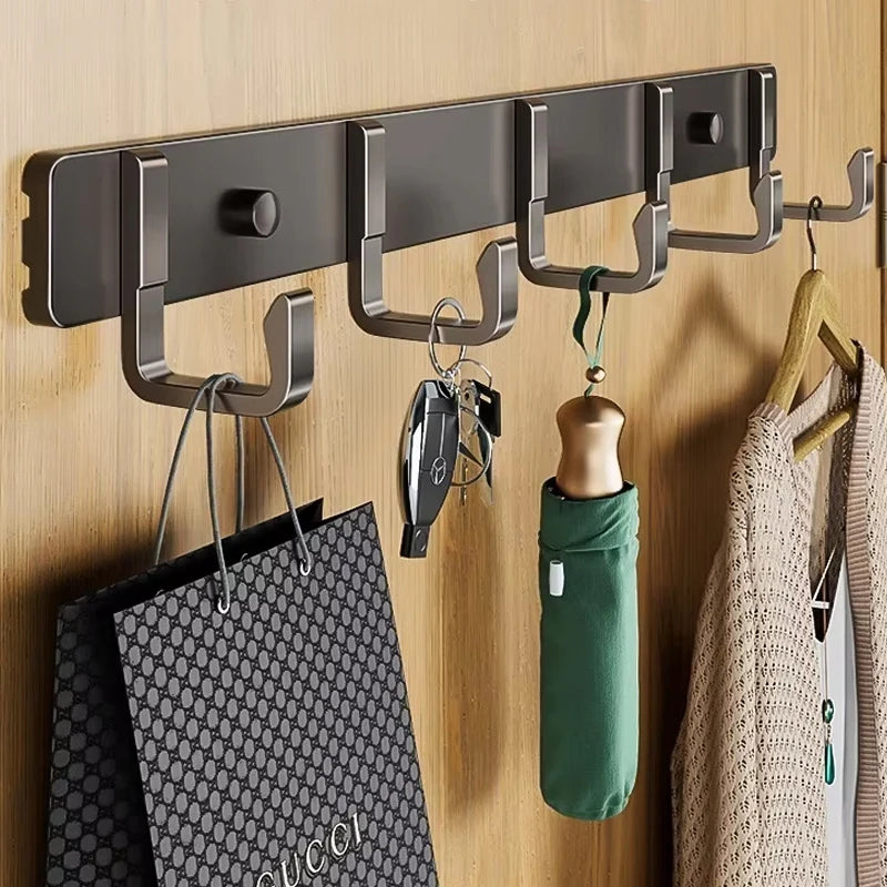 black aluminum wall hook rack with five hooks holding bag, keys, umbrella, and sweater in entryway