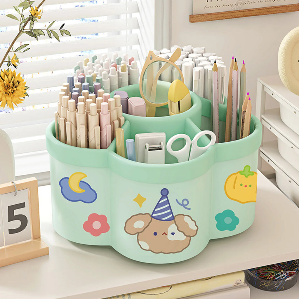 Green kawaii rotating desk organizer holding pens, pencils, and scissors on a study table