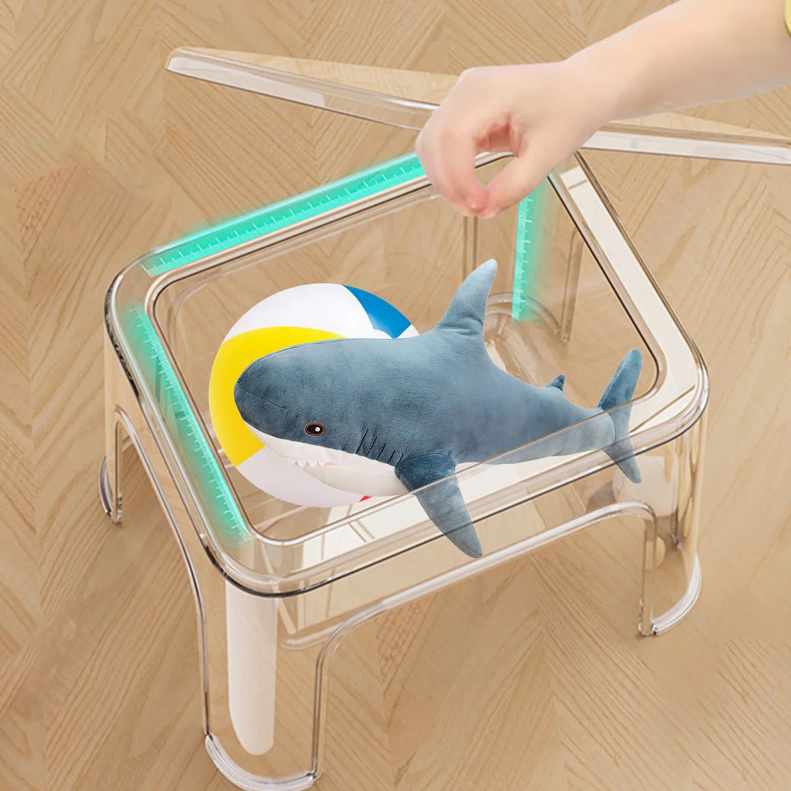 Transparent step stool with lid open, stuffed animal and beach ball stored inside