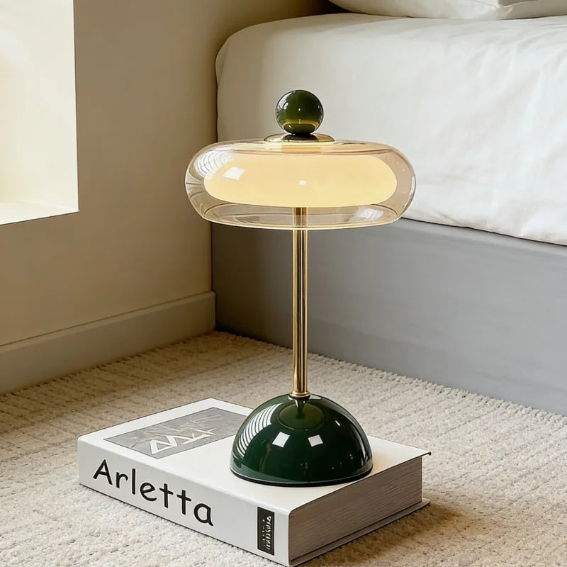 Mushroom table lamp with green base and glass shade on bedside