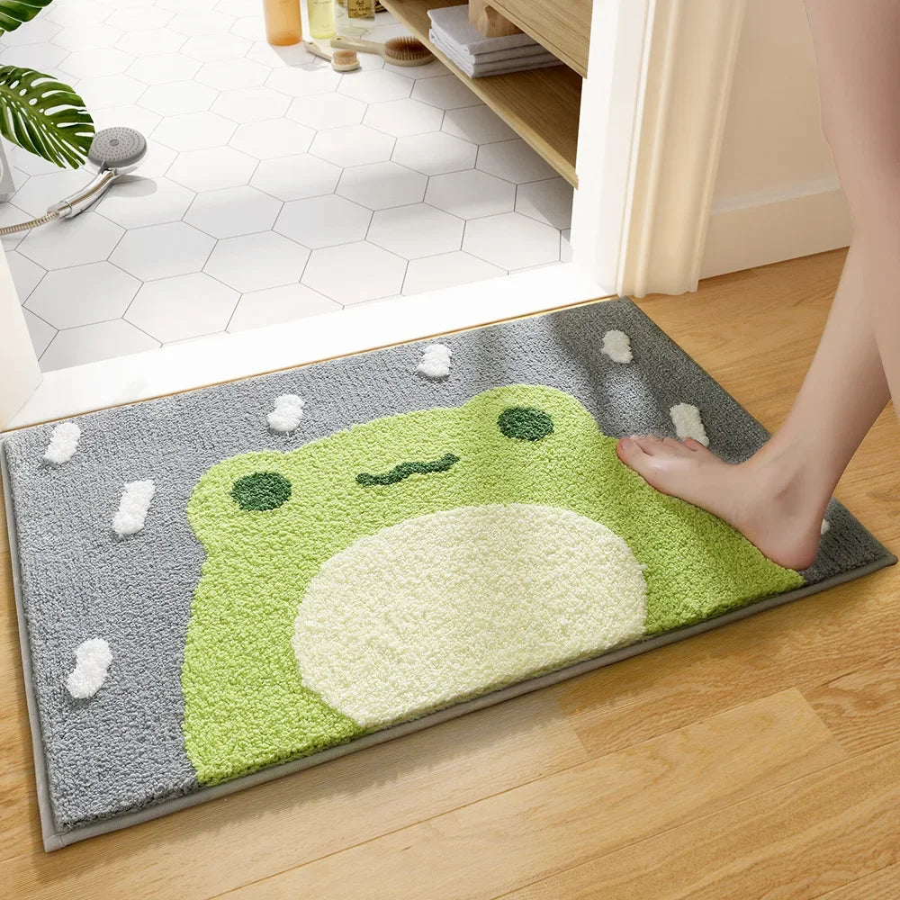 Frog cartoon microfiber bath mat at a bathroom doorway, foot stepping onto rug