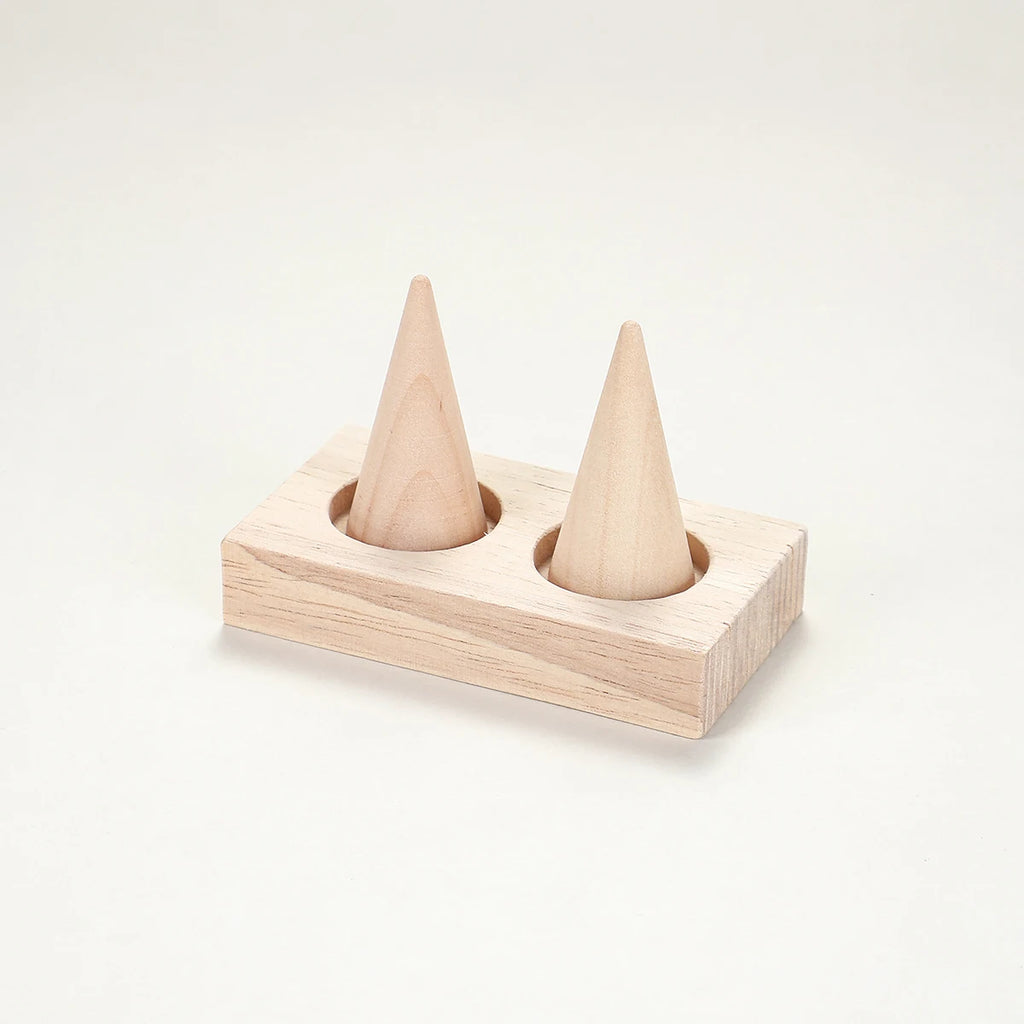 two-cone wood ring holder stand on a neutral background