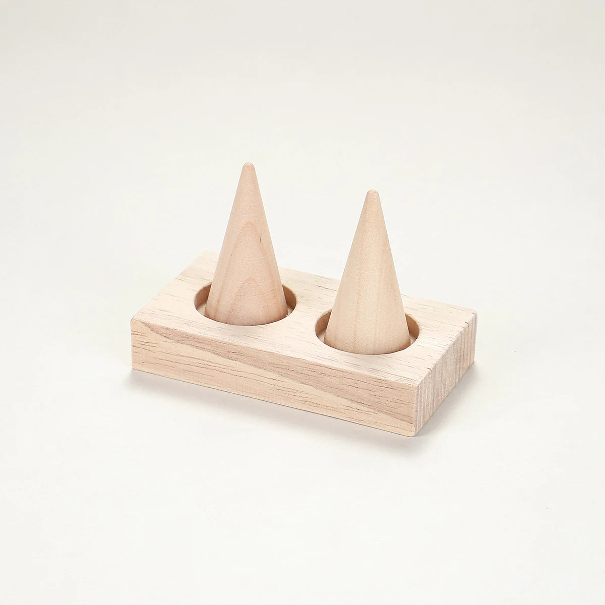 two-cone wood ring holder stand on a neutral background