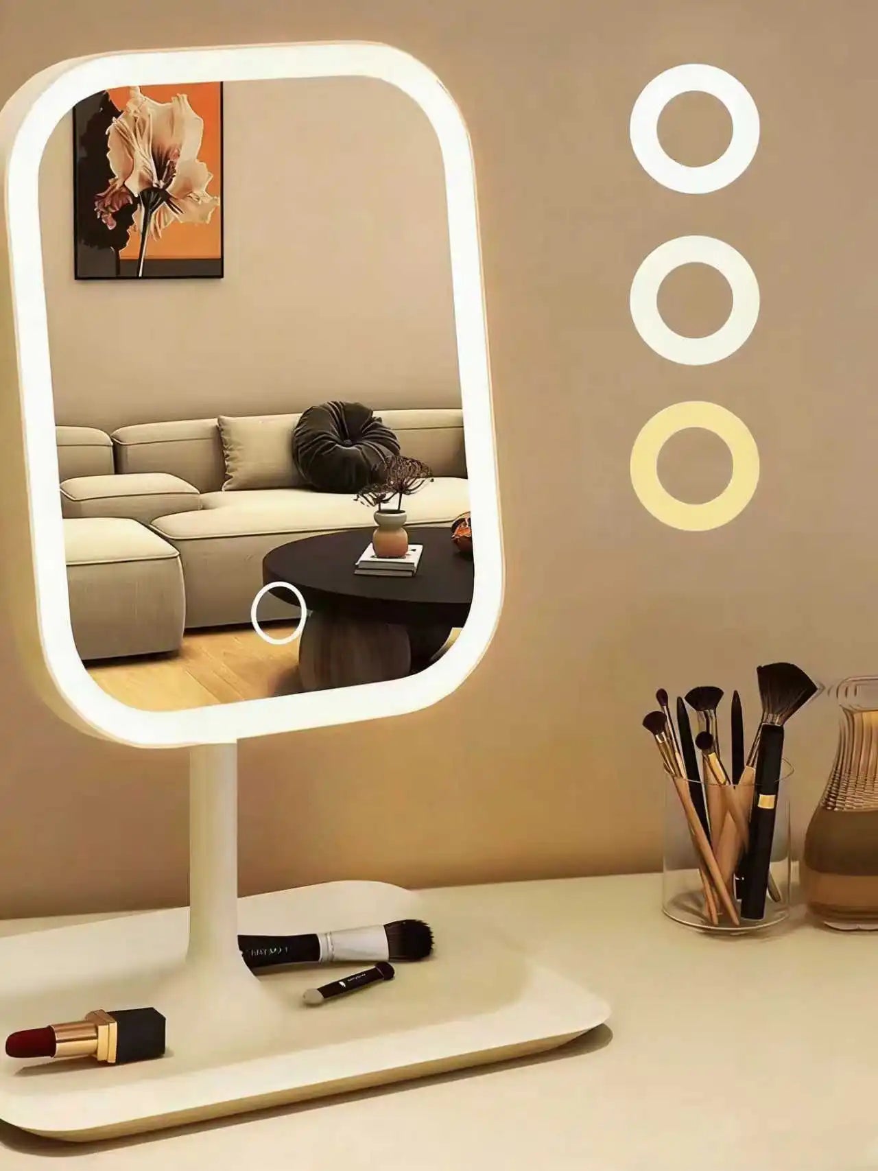Vanity mirror with 3 light modes displayed beside makeup on a tray