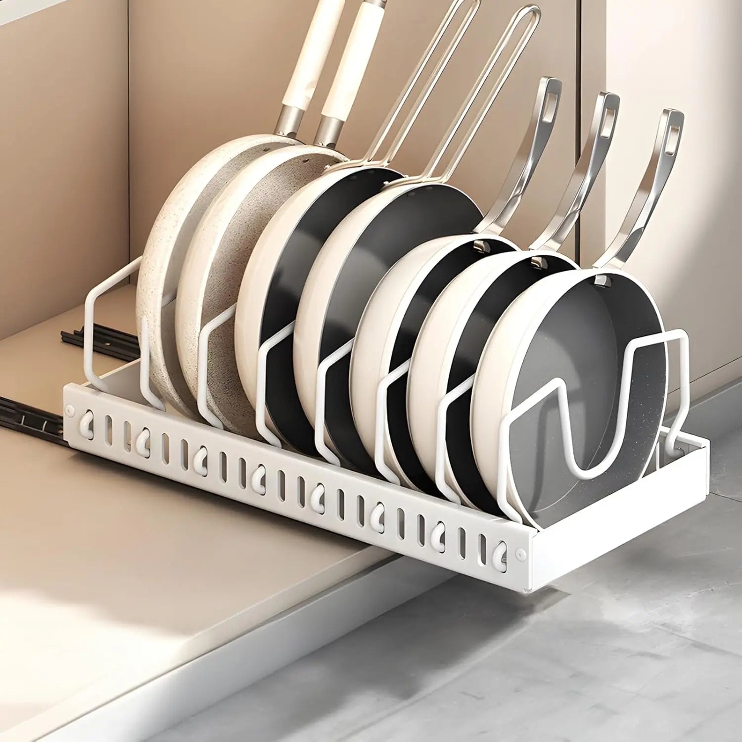 white pull-out pots and pans organizer holding cookware in a kitchen cabinet
