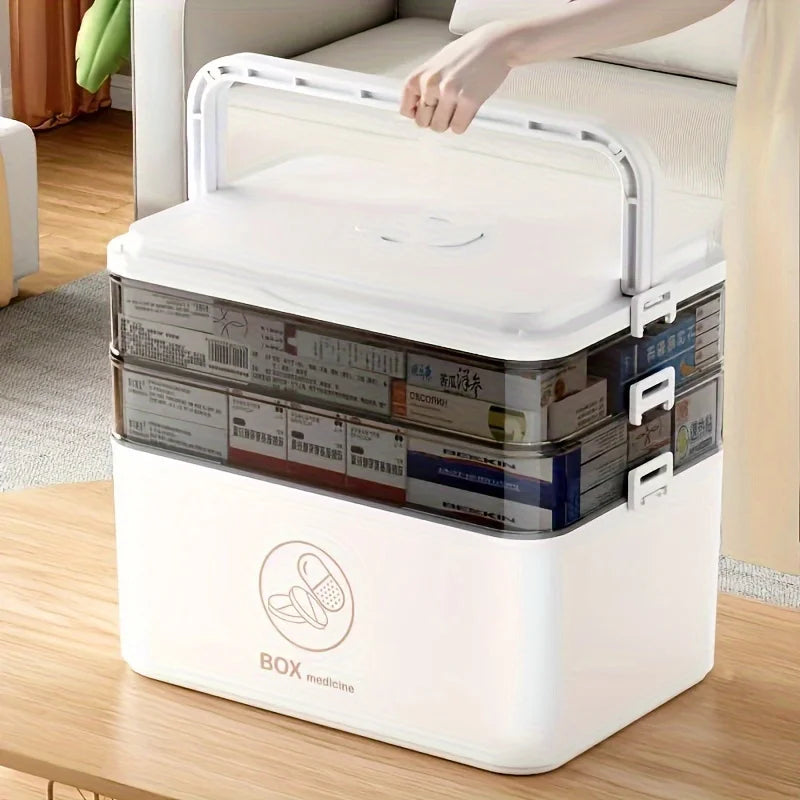 Person lifting the handle of the medicine organizer box, showing portable design.