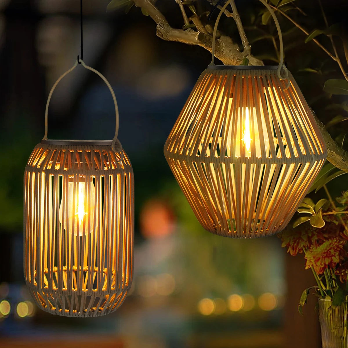 Two woven bamboo solar lanterns hanging from a tree and glowing at night in a garden setting