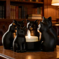 Black sculpted cat candle holder displayed on a wooden table in a cozy living room