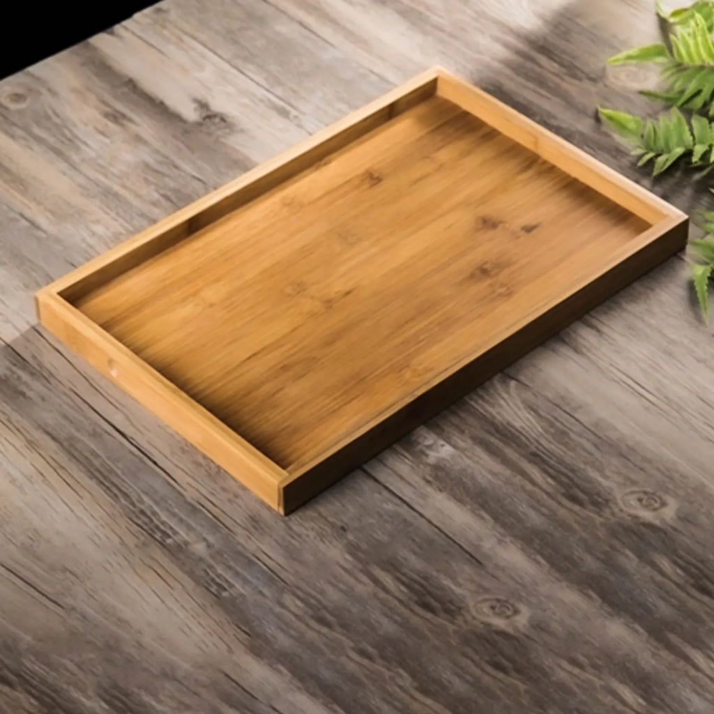 Single rectangular wood serving tray on a rustic wood tabletop