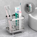 Stainless steel toothbrush holder on bathroom counter holding toothbrushes and toothpaste, with inset showing wall-mounted use