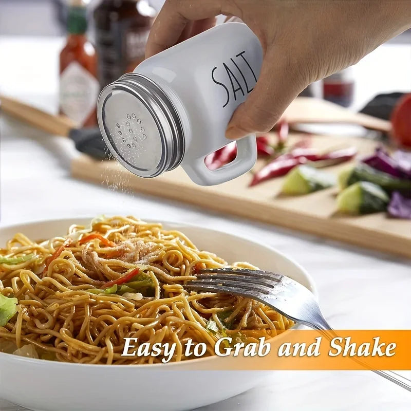 Glass salt shaker being used to season noodles at a kitchen table