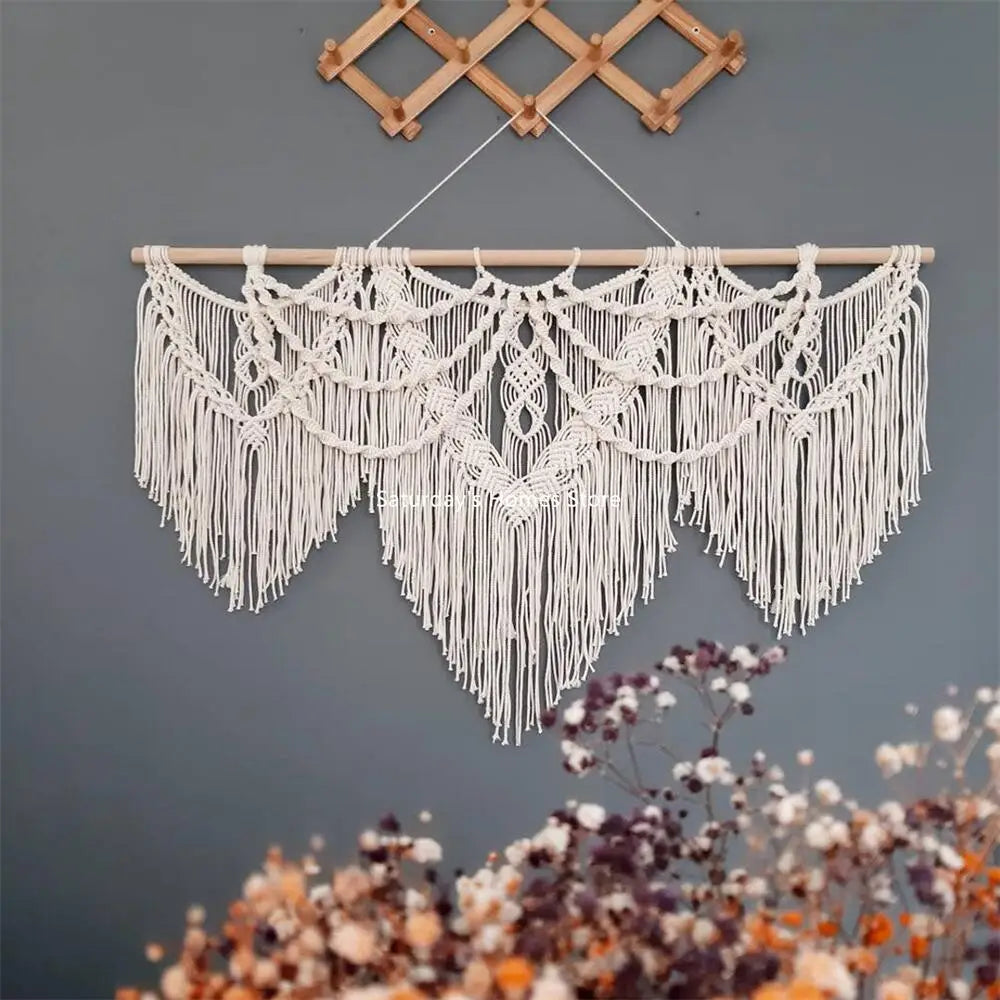 boho macrame wall hanging styled in living room with decorative wood accents