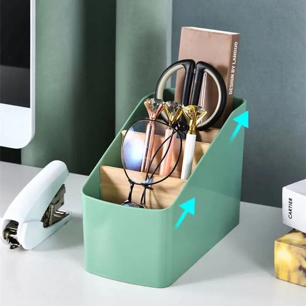 Green organizer on a desk holding scissors, glasses, and pens