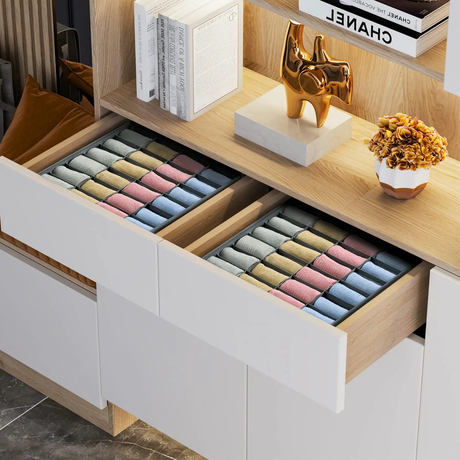 Two drawer organizers with rolled pastel socks arranged neatly inside a white wood drawer