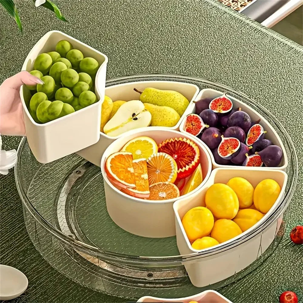 Hand removing a compartment filled with green grapes from the divided snack tray