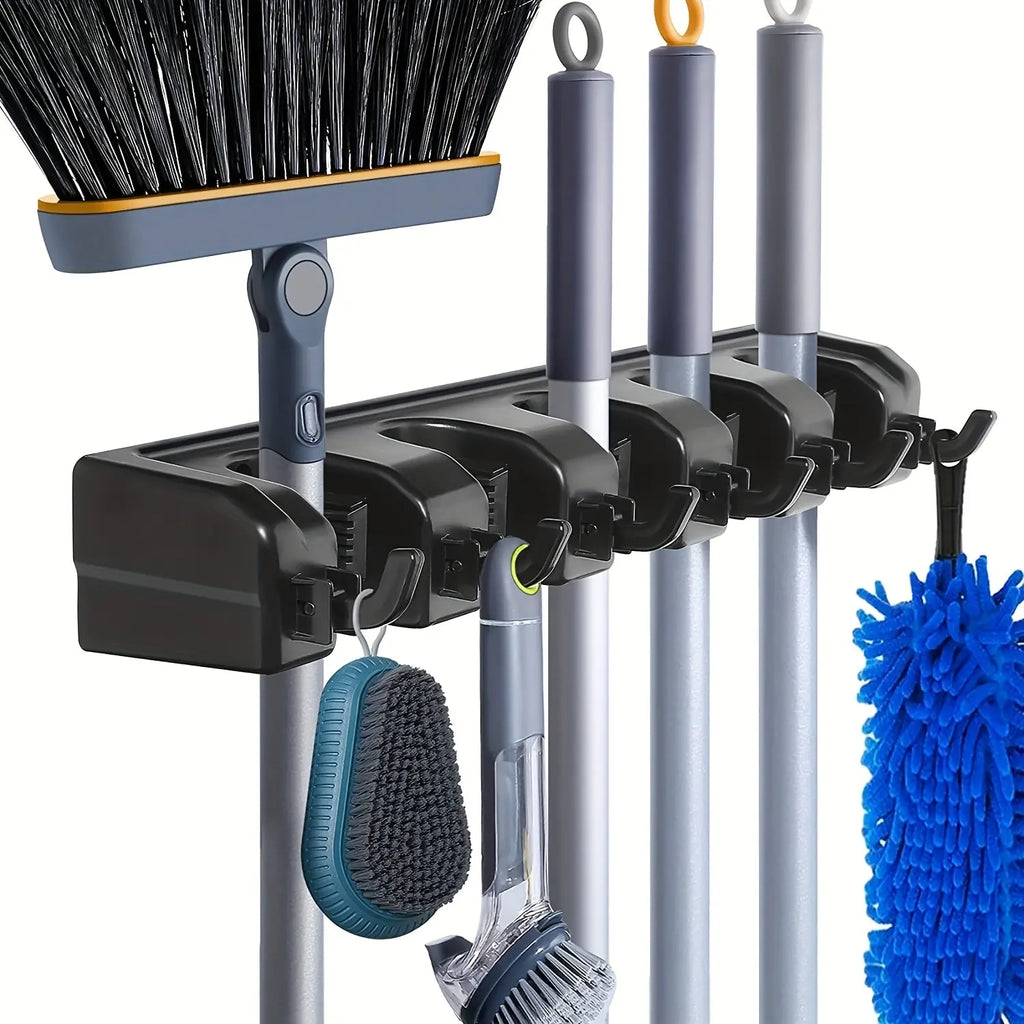 Black wall-mounted mop and broom holder rack storing various cleaning tools