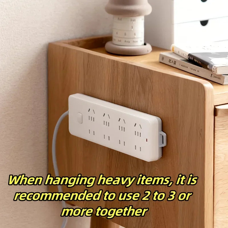 Power strip mounted on side of wooden nightstand using adhesive magnetic holder