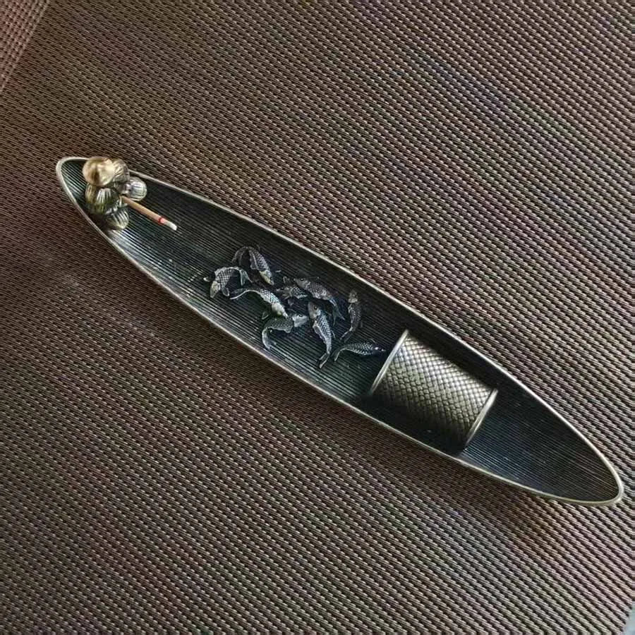 Top view of fisherman incense stick holder showing koi fish detail inside tray