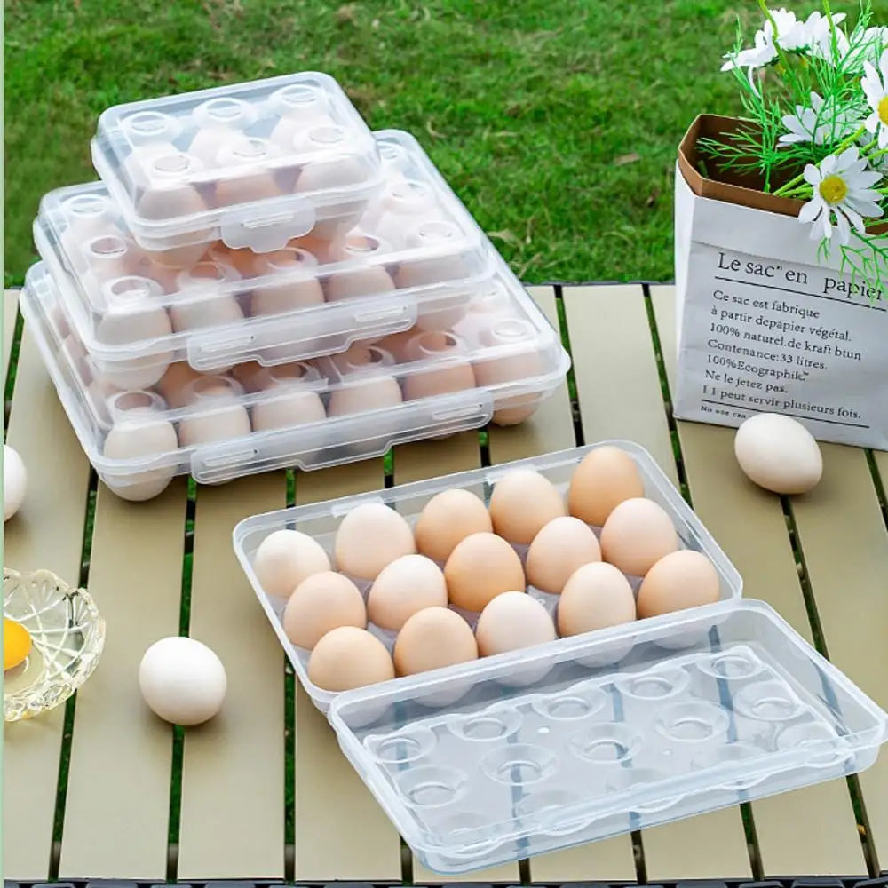 four plastic egg containers with eggs on a picnic table, one open with eggs visible inside