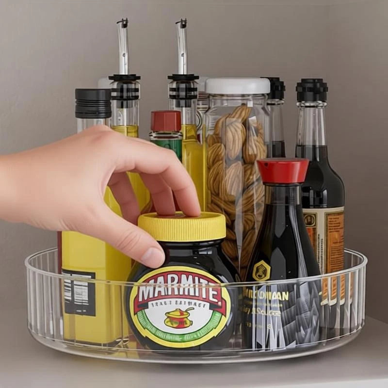 Hand reaching for a jar from a clear round lazy susan tray filled with condiments
