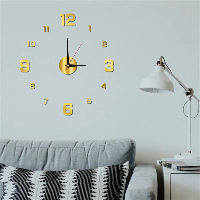 Gold frameless 3D wall clock sticker on a light wall above a grey sofa in a living space