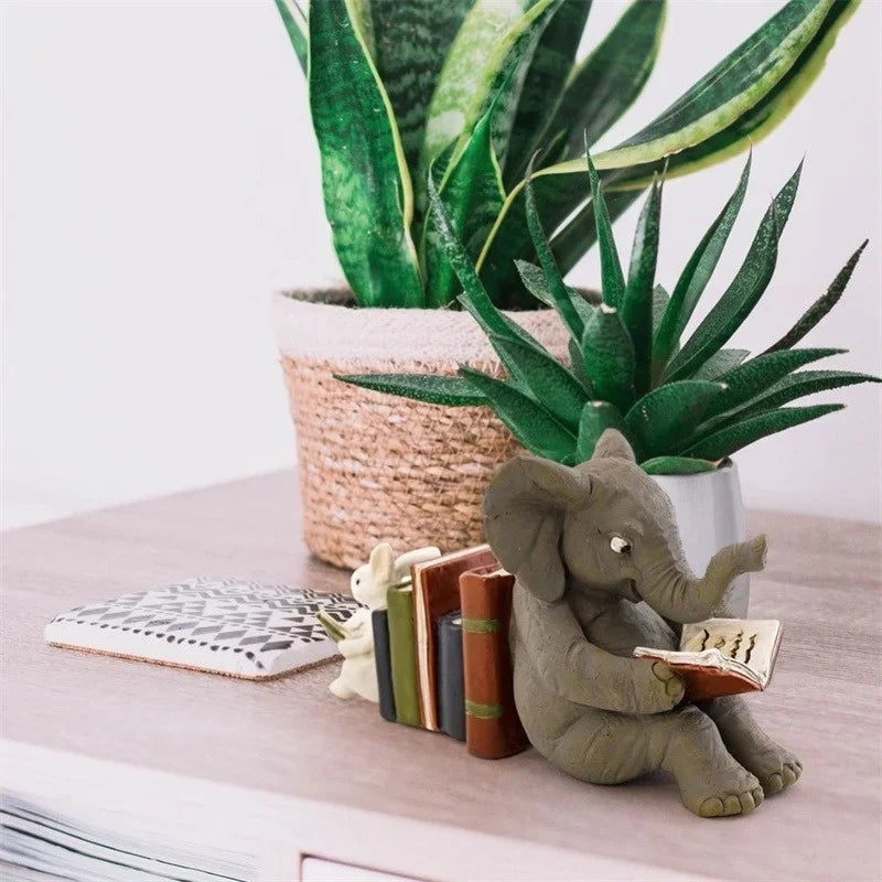 Elephant and rabbit bookend placed on a shelf next to potted plants