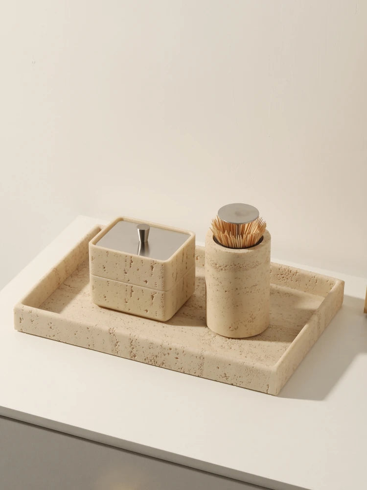 Beige travertine rectangular tray with matching bathroom accessories on a counter