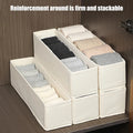 Slim beige fabric drawer organizer bins stacked and filled with neatly folded socks inside a wooden closet