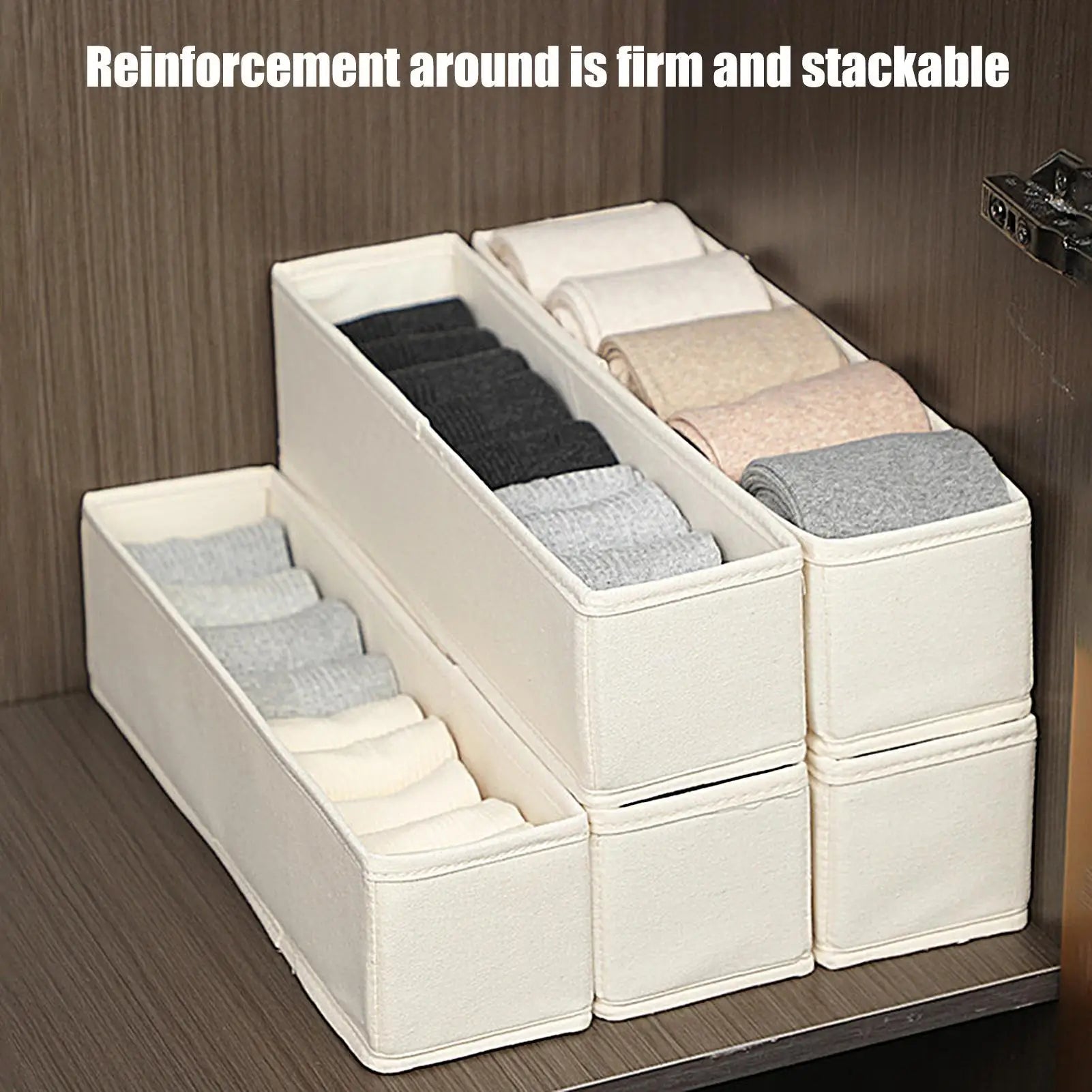 Slim beige fabric drawer organizer bins stacked and filled with neatly folded socks inside a wooden closet
