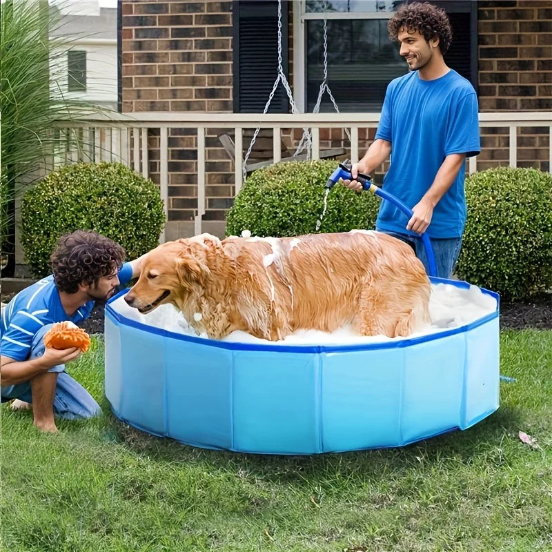 Large golden retriever being bathed in a blue collapsible dog bath tub on a grassy lawn