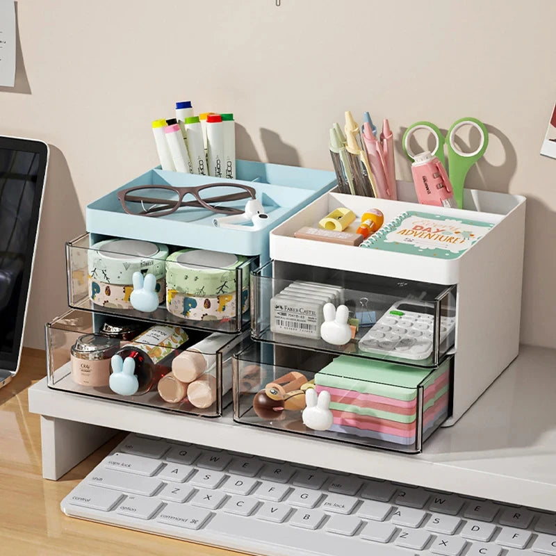 Small desk organizer with drawers holding stationery and office supplies on a desktop