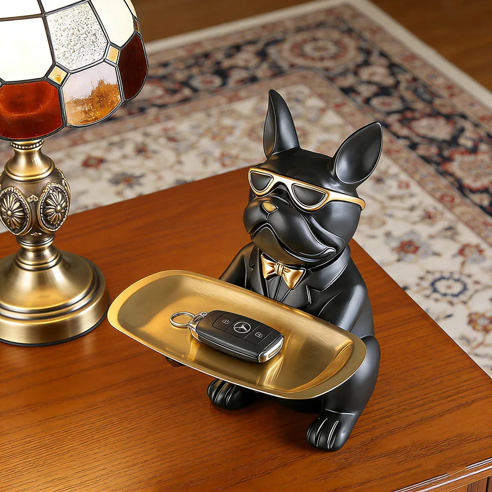 Black bulldog tray used for keys on a living room side table
