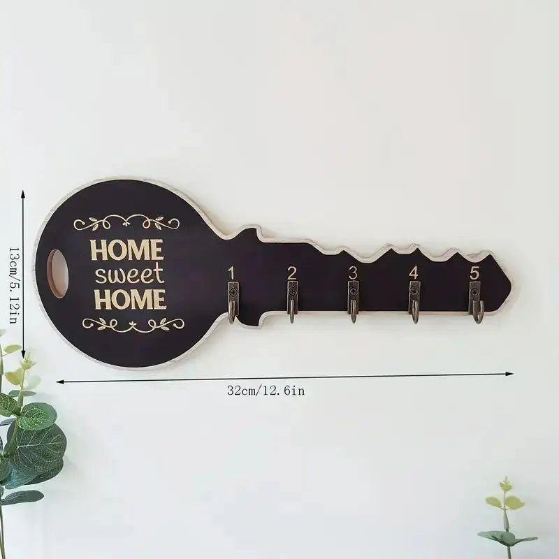 Black key-shaped key holder on wall with clear measurement lines showing length and height
