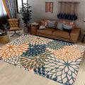 Botanical floral area rug with blue, orange, and green pattern in cozy living room