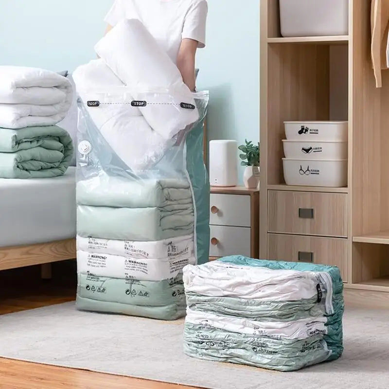 A person places bedding into a clear no-pump vacuum storage bag in a tidy bedroom setting